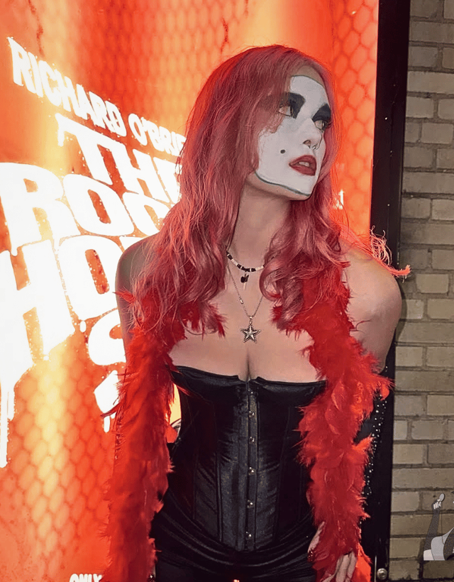 claire in front of the rocky horror show poster dressed as floorshow janet