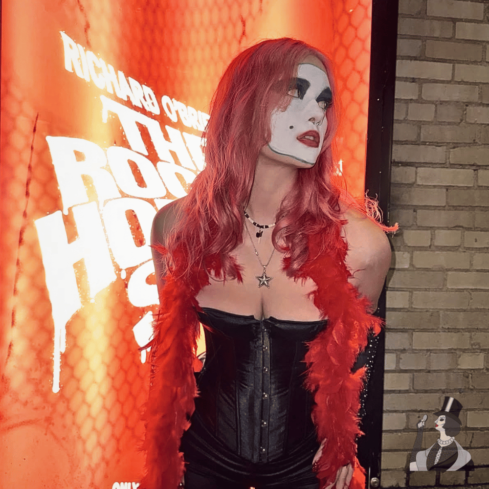 claire in front of the rocky horror show poster dressed as floorshow janet
